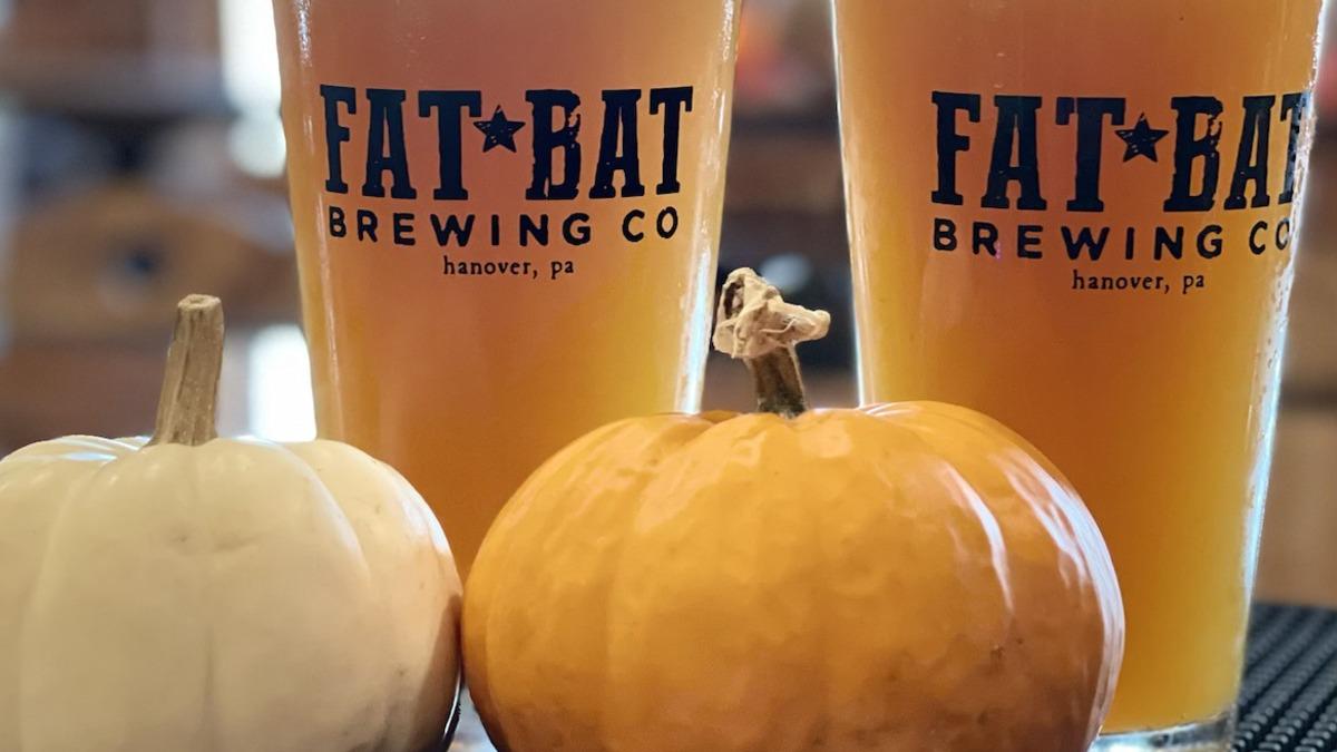 Two glasses of orange-colored beer with the