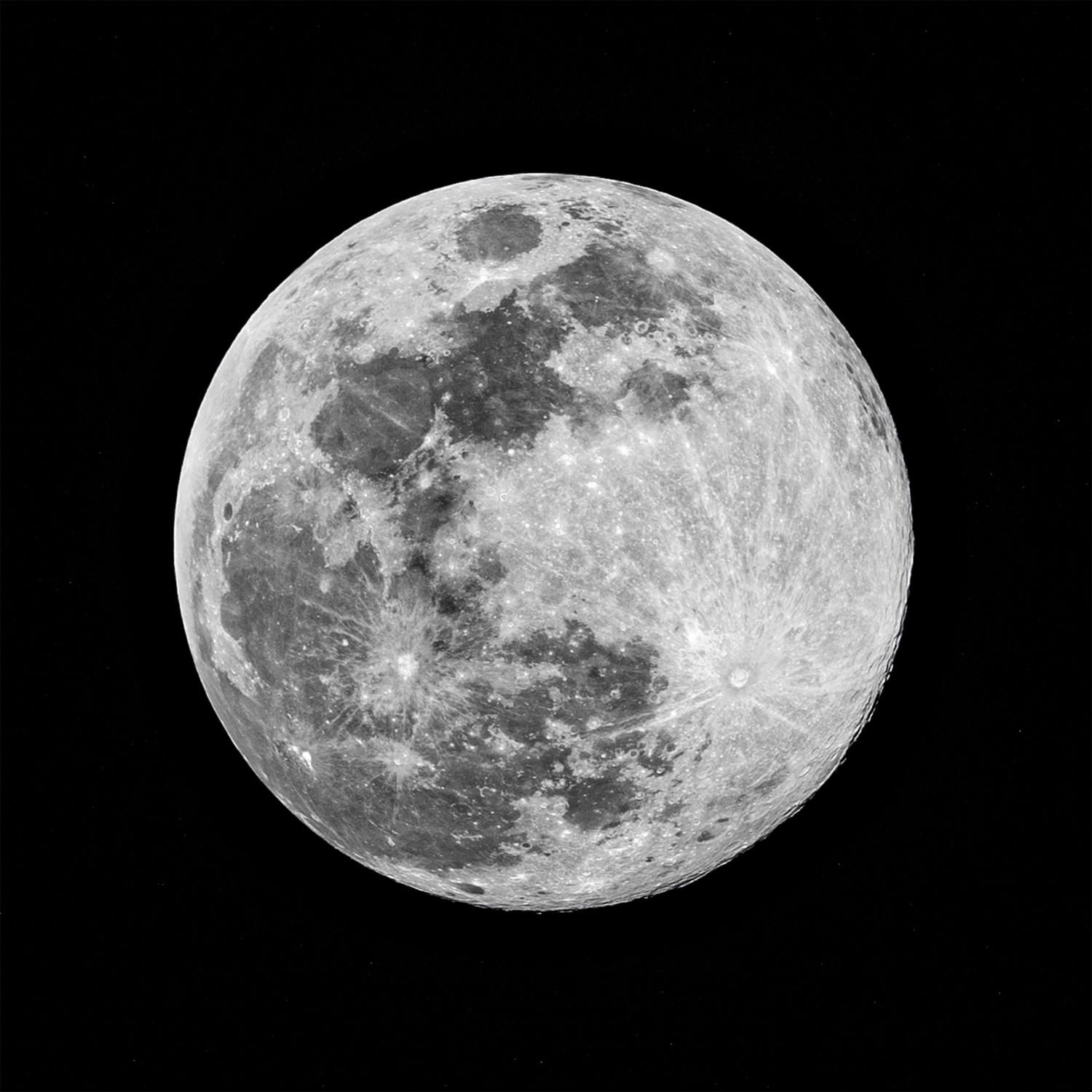 A high-resolution, grayscale full moon displays a heavily cratered surface with distinct dark maria against the black expanse of space.